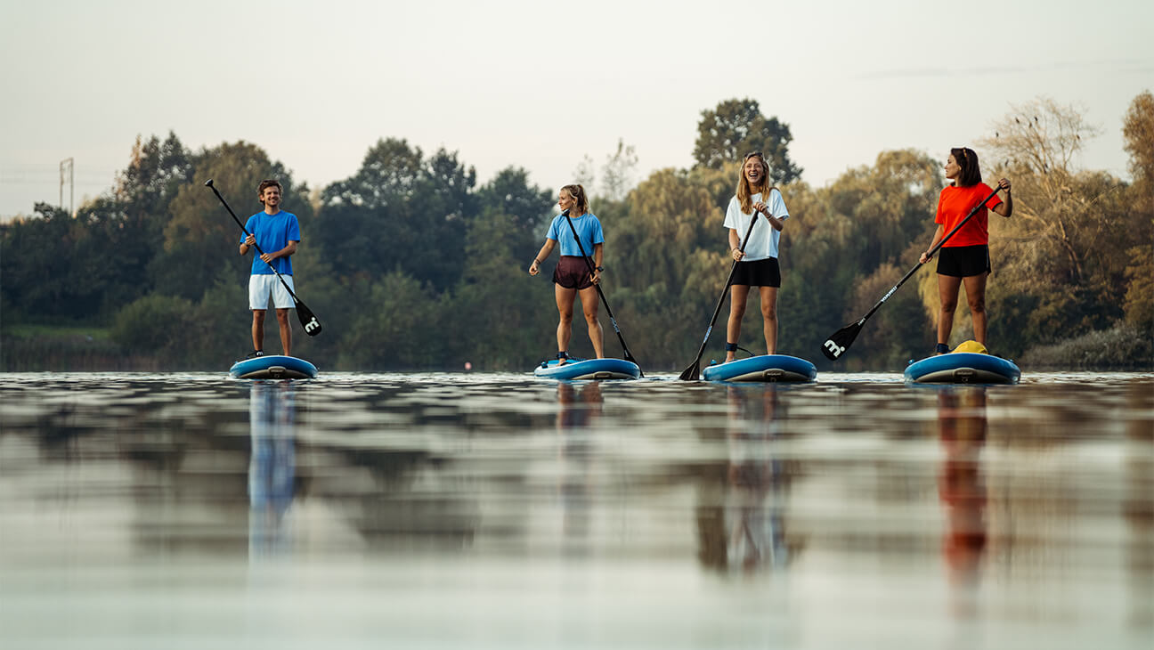 Groep jongeren op SUP boards  op het water