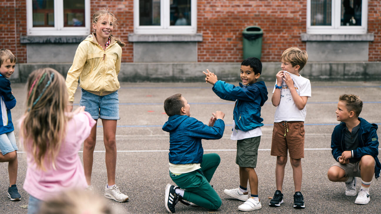 zesdejaars leren de kleintjes spelletjes aan die ze tijdens de speeltijd kunnen spelen